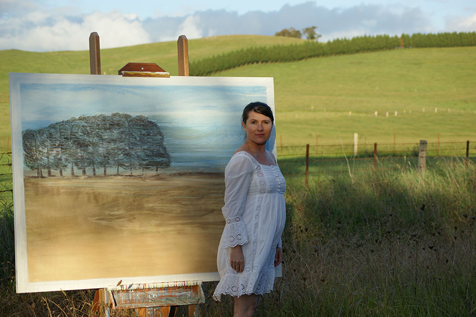 Cathie Alexander with painting in the highlands